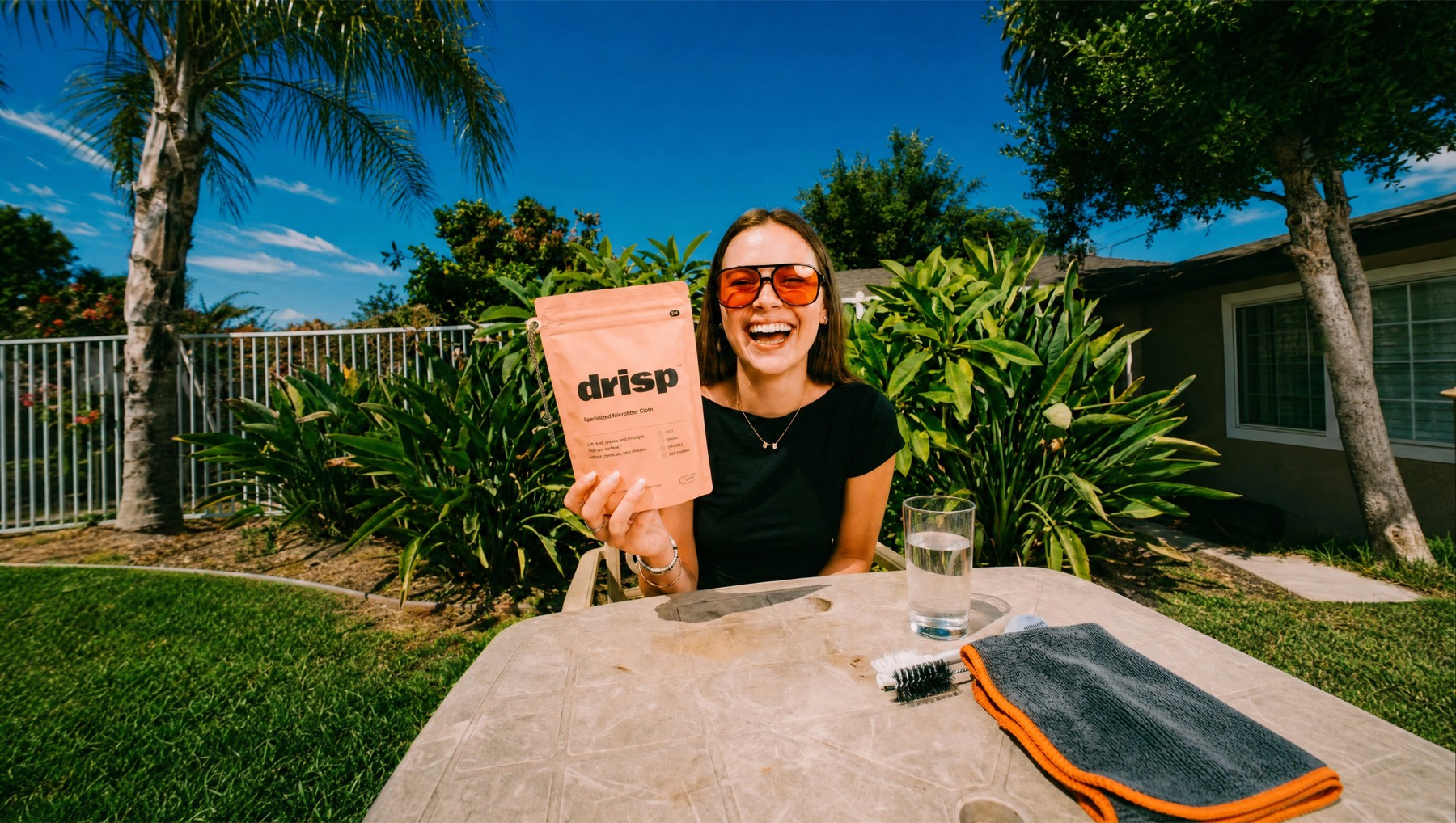 A happy customer holding a Drisp pack — a brand built with Brandboot